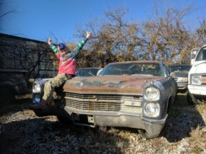 junk car cadillac old junk cadillac with a crazy kid